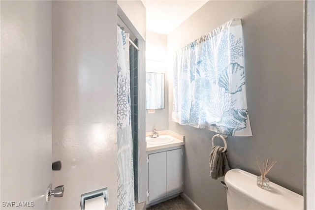 bathroom featuring toilet and vanity