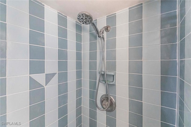 bathroom with tiled shower