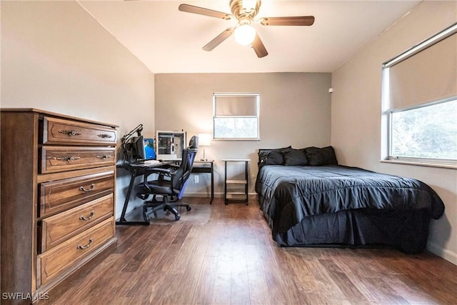 bedroom with ceiling fan and dark hardwood / wood-style flooring