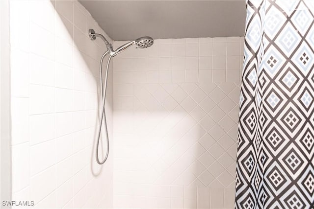 bathroom with tiled shower