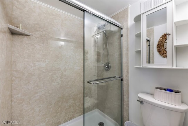 full bathroom with a shower stall and toilet