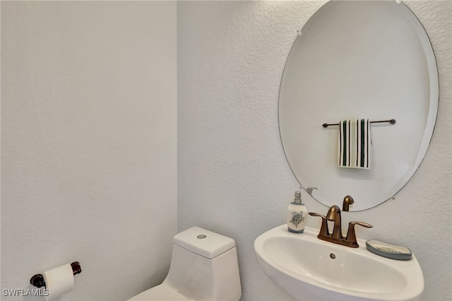 bathroom featuring sink and toilet