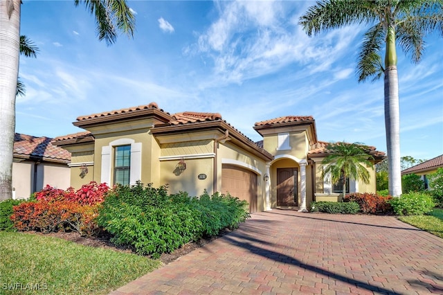 mediterranean / spanish home featuring a garage