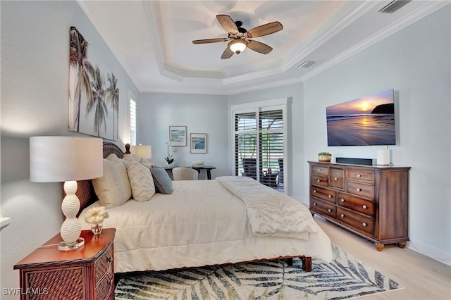 bedroom featuring access to exterior, a tray ceiling, ornamental molding, and ceiling fan