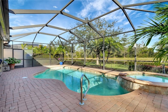 view of pool featuring a patio area, an in ground hot tub, and glass enclosure