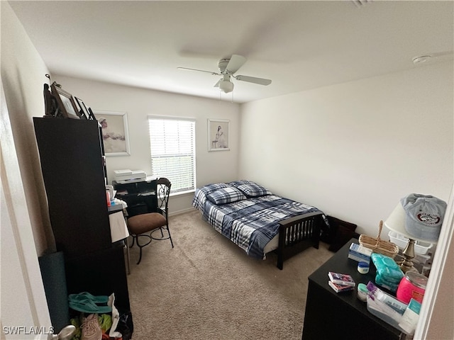 bedroom featuring ceiling fan and carpet