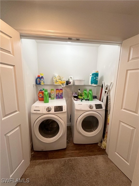 laundry area with dark hardwood / wood-style floors and washing machine and clothes dryer