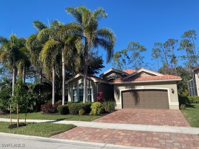 view of front of home with a garage and a front lawn