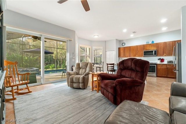 living room with a ceiling fan, recessed lighting, visible vents, and light tile patterned floors