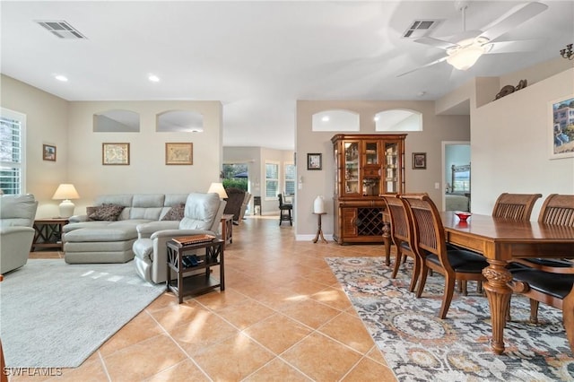 living room with light tile patterned floors and ceiling fan