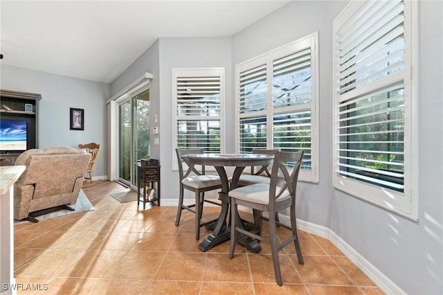 dining area featuring baseboards and light tile patterned floors