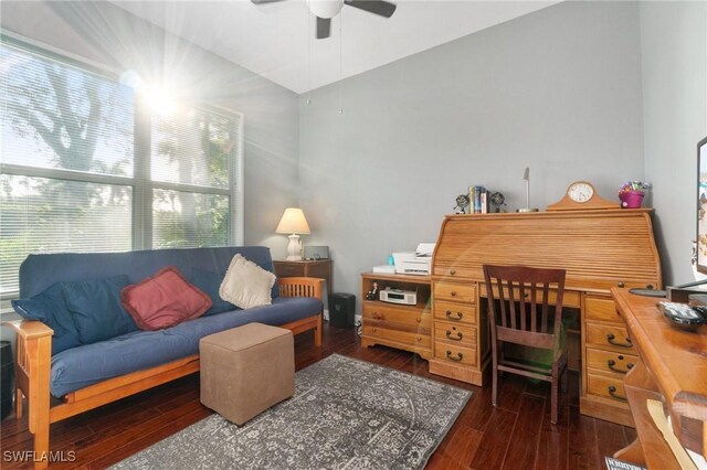 living room featuring dark wood-type flooring, ceiling fan, and vaulted ceiling