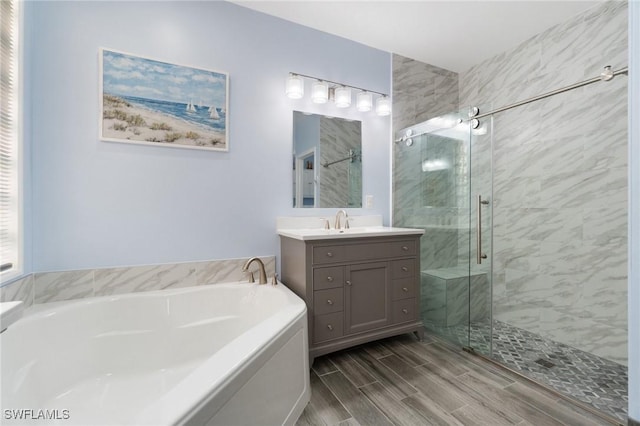 bathroom featuring vanity and separate shower and tub