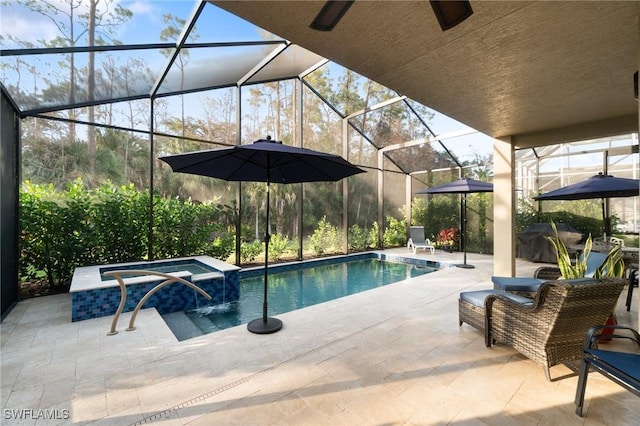 view of pool with a lanai, a patio area, and a pool with connected hot tub