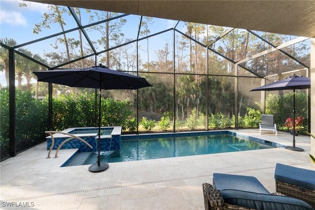 view of pool featuring an in ground hot tub, a lanai, and a patio area