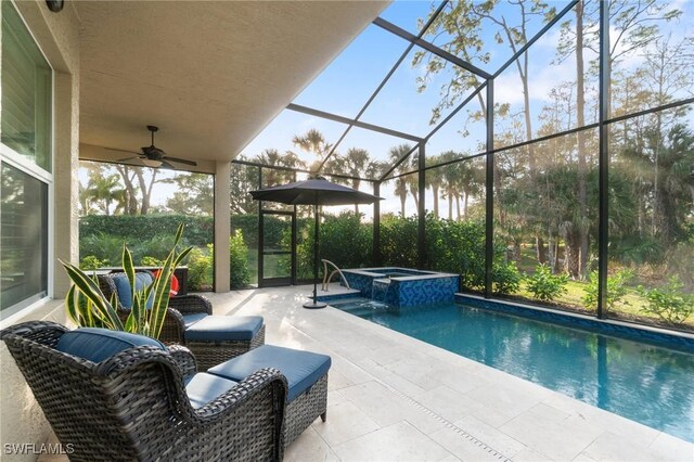 view of swimming pool with a lanai, a patio, and an in ground hot tub