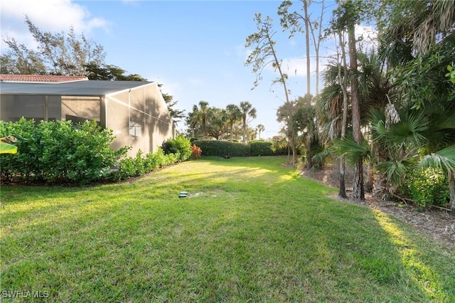 view of yard with a lanai