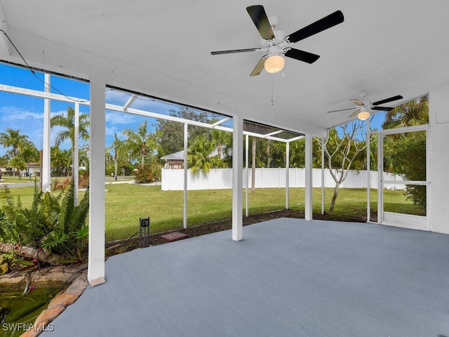 unfurnished sunroom with ceiling fan