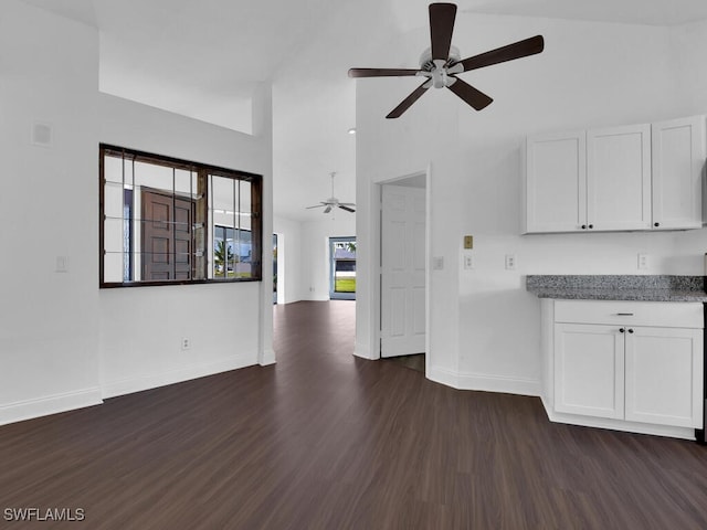 kitchen with white cabinets, dark hardwood / wood-style floors, high vaulted ceiling, and ceiling fan