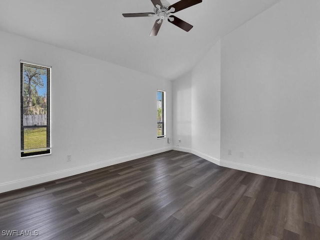 spare room with vaulted ceiling, ceiling fan, and dark hardwood / wood-style flooring