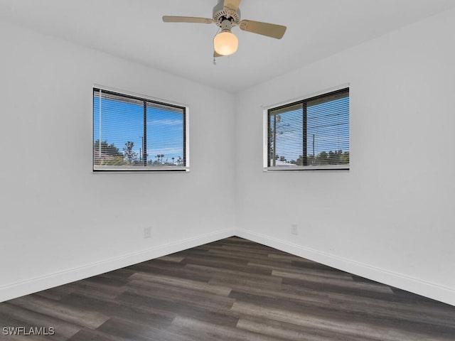 spare room featuring ceiling fan and dark hardwood / wood-style floors