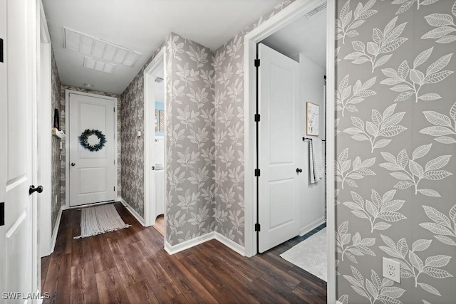 corridor with dark hardwood / wood-style flooring