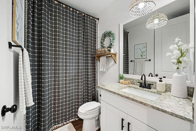 bathroom with toilet, an inviting chandelier, wood-type flooring, and vanity