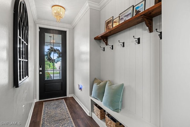 mudroom featuring dark wood-type flooring, ornamental molding, and an inviting chandelier