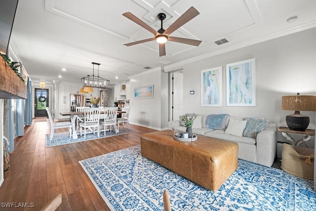 living room featuring ceiling fan, ornamental molding, and hardwood / wood-style flooring