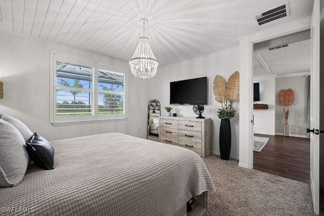 carpeted bedroom featuring a chandelier