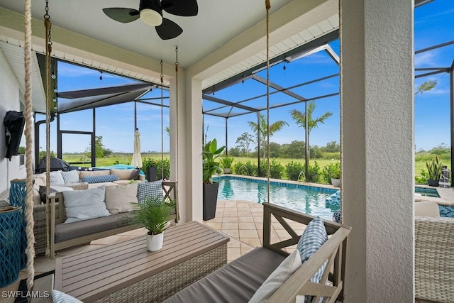 view of swimming pool with a lanai, an outdoor hangout area, ceiling fan, and a patio area