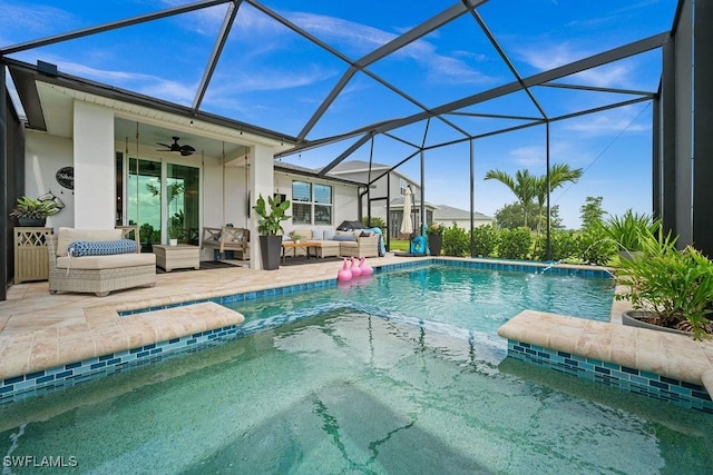 view of swimming pool with ceiling fan, pool water feature, a lanai, an outdoor hangout area, and a patio