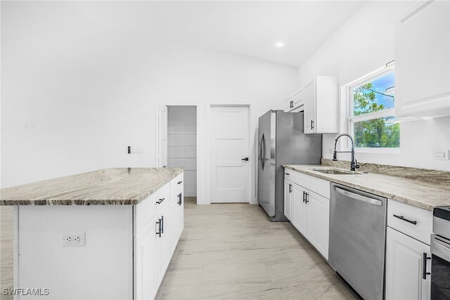 27159 Alhambra Dr, Punta Gorda, FL 33955 - kitchen with appliances with stainless steel finishes, a sink, white cabinetry, light marble finish flooring, and recessed lighting