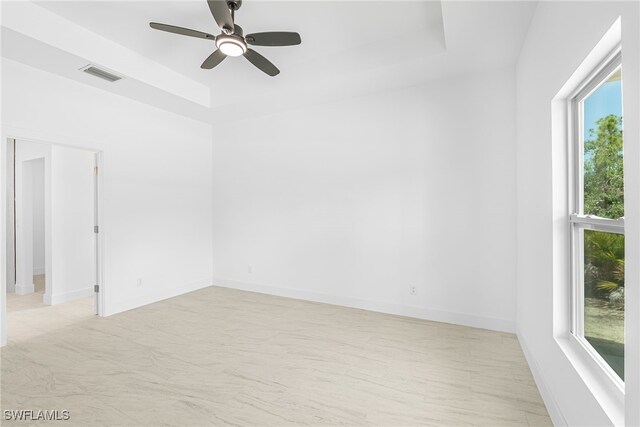 27159 Alhambra Dr, Punta Gorda, FL 33955 - spare room with a tray ceiling, ceiling fan, and baseboards