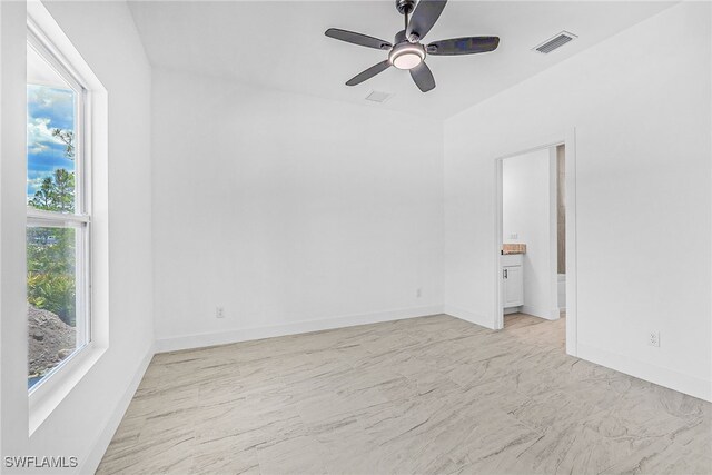27159 Alhambra Dr, Punta Gorda, FL 33955 - empty room featuring ceiling fan, baseboards, and light marble finish floors