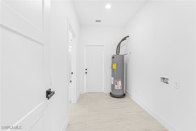 27159 Alhambra Dr, Punta Gorda, FL 33955 - corridor with water heater, light marble finish flooring, baseboards, and recessed lighting