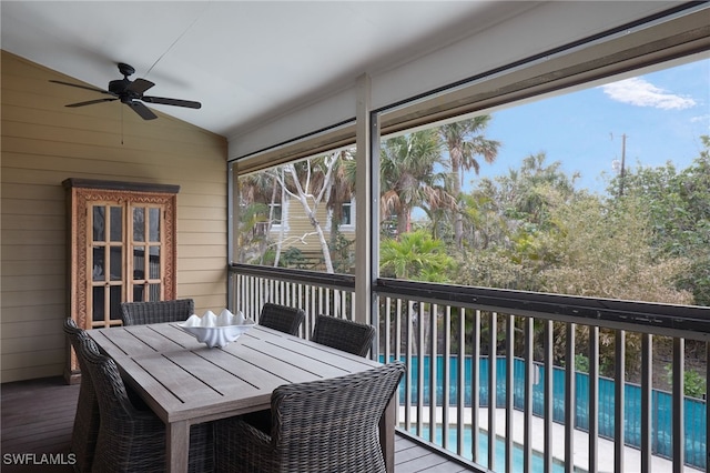 sunroom with ceiling fan and lofted ceiling