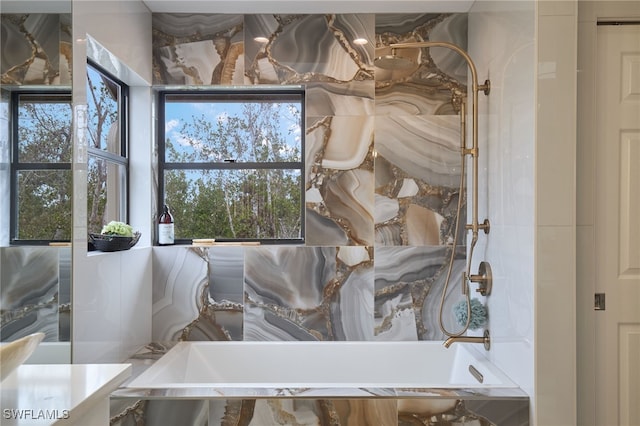 bathroom featuring tiled tub