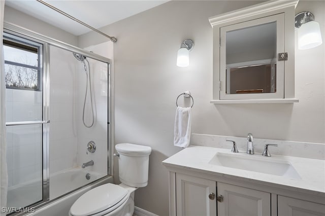 full bathroom featuring toilet, enclosed tub / shower combo, and vanity