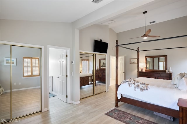 bedroom with ceiling fan, ensuite bathroom, light hardwood / wood-style flooring, and high vaulted ceiling