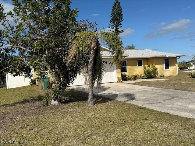 view of front of house featuring a garage and a front lawn