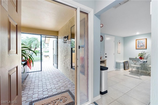 corridor with light tile patterned flooring