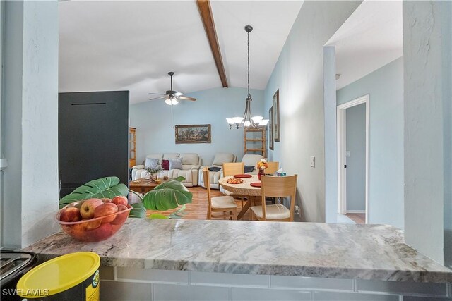 dining space featuring ceiling fan with notable chandelier and lofted ceiling with beams