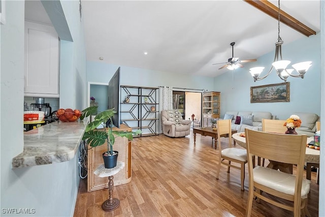 living room featuring light wood-type flooring, ceiling fan with notable chandelier, and lofted ceiling with beams