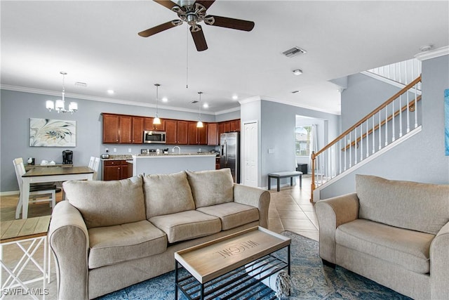 living room with ceiling fan with notable chandelier, crown molding, and tile patterned floors