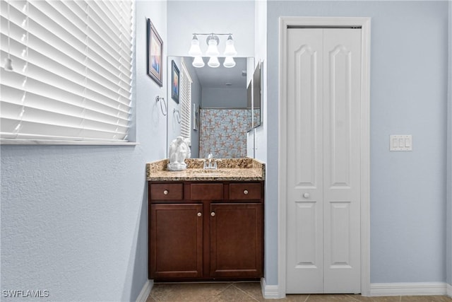 bathroom with vanity, tile patterned floors, and curtained shower