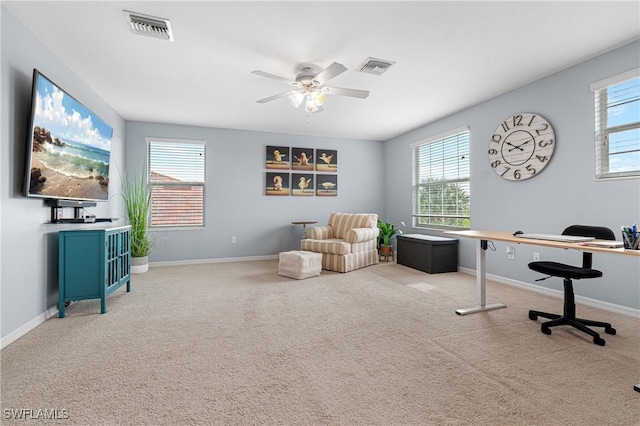 carpeted office featuring ceiling fan