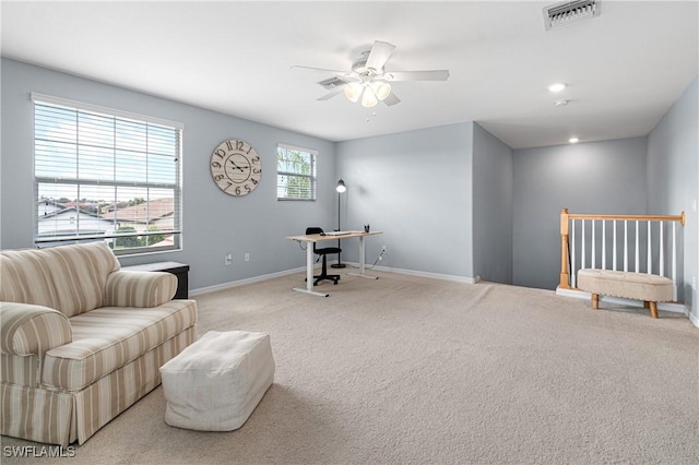 office area featuring ceiling fan and light carpet