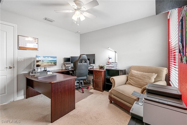 carpeted office space featuring ceiling fan