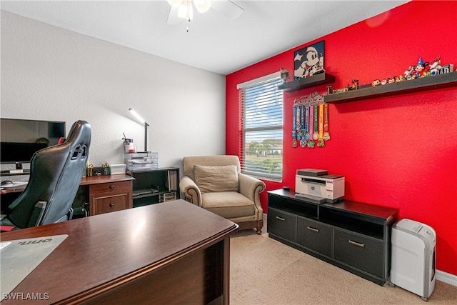 carpeted office space with ceiling fan